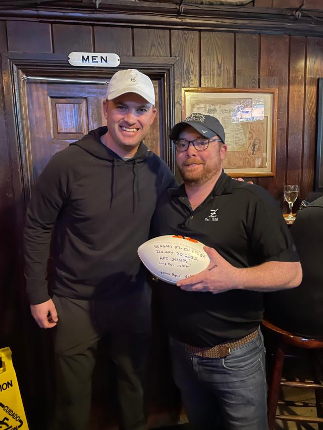 Bengals coach Zac Taylor delivers game ball to fans at a bar