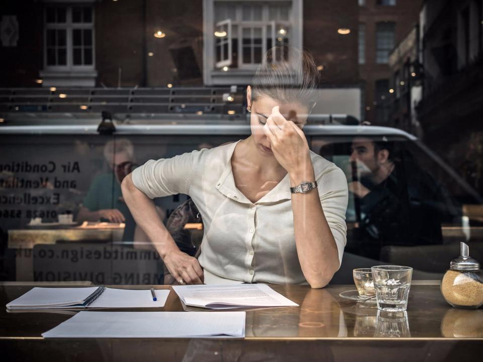 woman and papers stressed