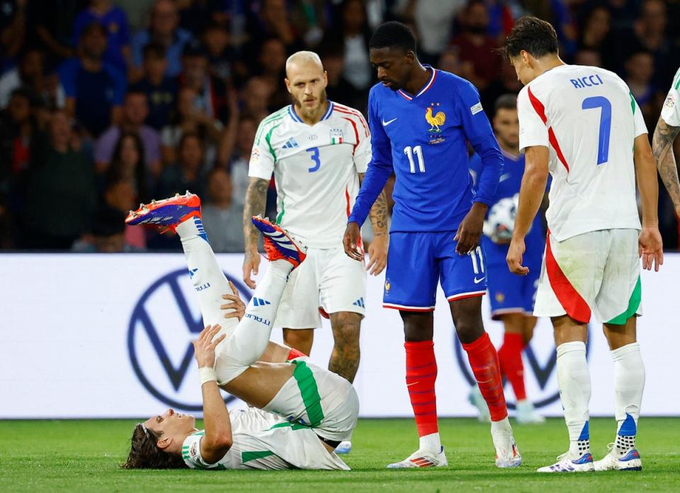 Injury blow: Arsenal defender Riccardo Calafiori was forced off as Italy beat France 3-1 in Paris (REUTERS)