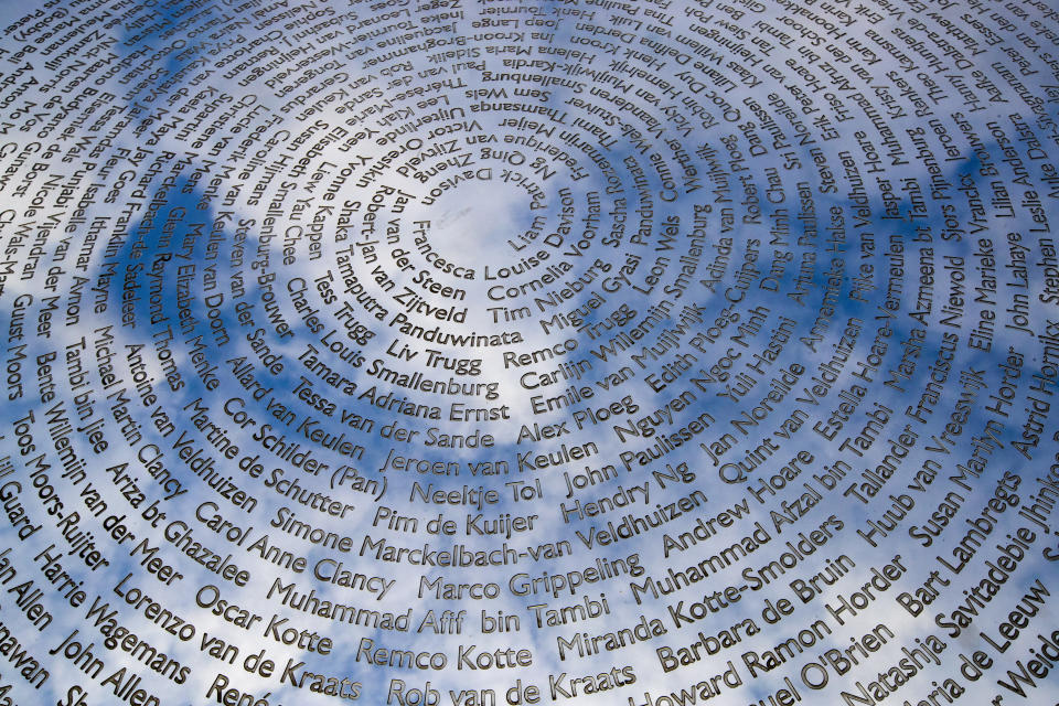 FILE- In this Friday, March 6, 2020, file photo, The sky is reflected in the national MH17 monument which carries the names of the victims of the downed Malaysia Airlines Flight 17 in Vijfhuizen, Netherlands, Friday, March 6, 2020. The trial in absentia in a Dutch courtroom of three Russians and a Ukrainian charged in the downing of Malaysia Airlines flight MH17 in 2014 moves to the merits phase, when judges and lawyers begin assessing evidence. (AP Photo/Peter Dejong, File)