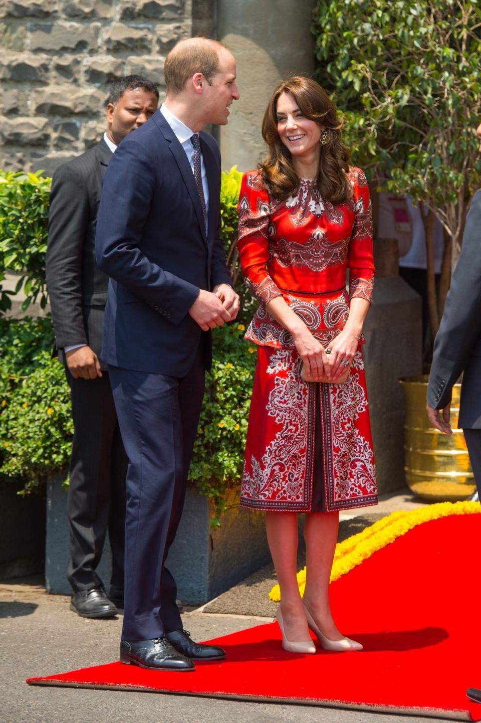<p>For the launch of the royal tour to India, Kate chose a bespoke Alexander McQueen suit featuring a peplum top and oriental print. L.K. Bennett heels and a suede clutch by Russell and Bromley complemented the ensemble. </p><p><i>[Photo: PA]</i></p>