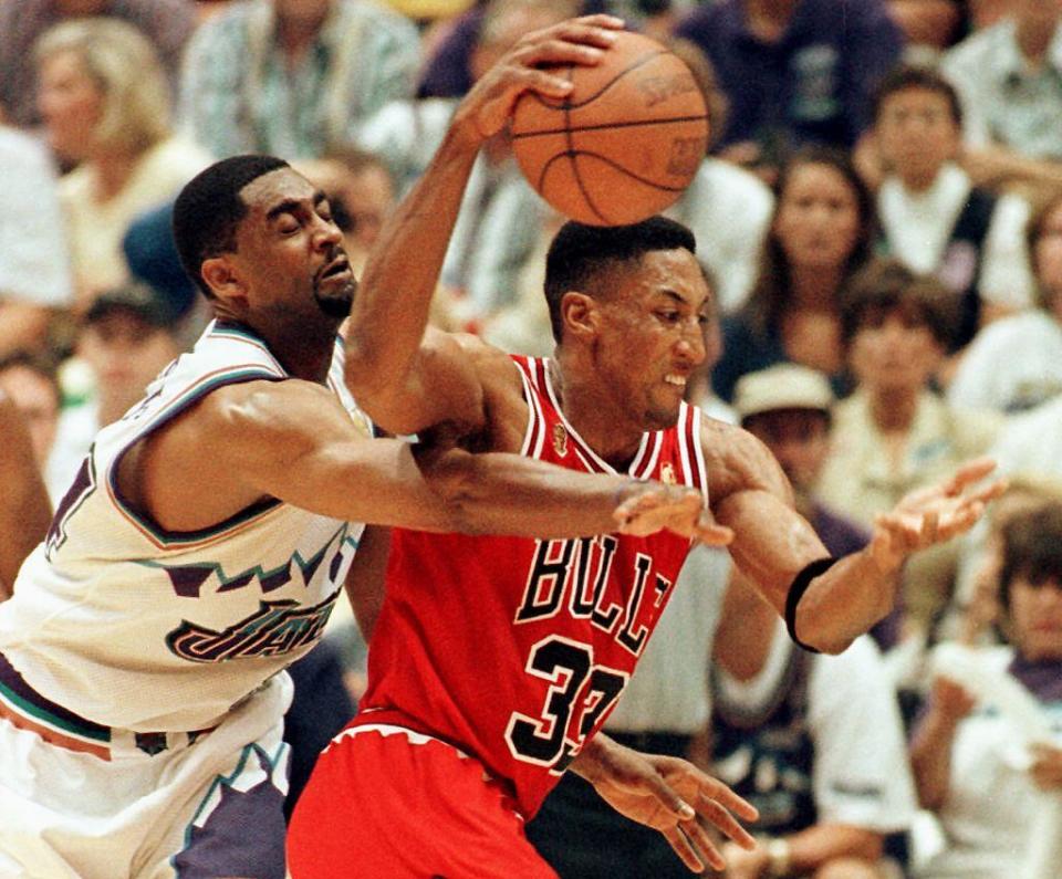 Scottie Pippen (R) of the Chicago Bulls eludes Chris Morris of the Utah Jazz 11 June during game five of the 1997 NBA Finals at the Delta Center in Salt Lake City, Utah. The best of seven series is tied at 2-2.   AFP PHOTO     Paul K. BUCK (Photo by PAUL BUCK / AFP) (Photo by PAUL BUCK/AFP via Getty Images)