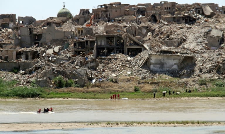 In this file photo, Iraqi civil defence search for bodies under the rubble of buildings in the northern city of Mosul on May 16, 2018, almost a year after the city was wrested back from IS