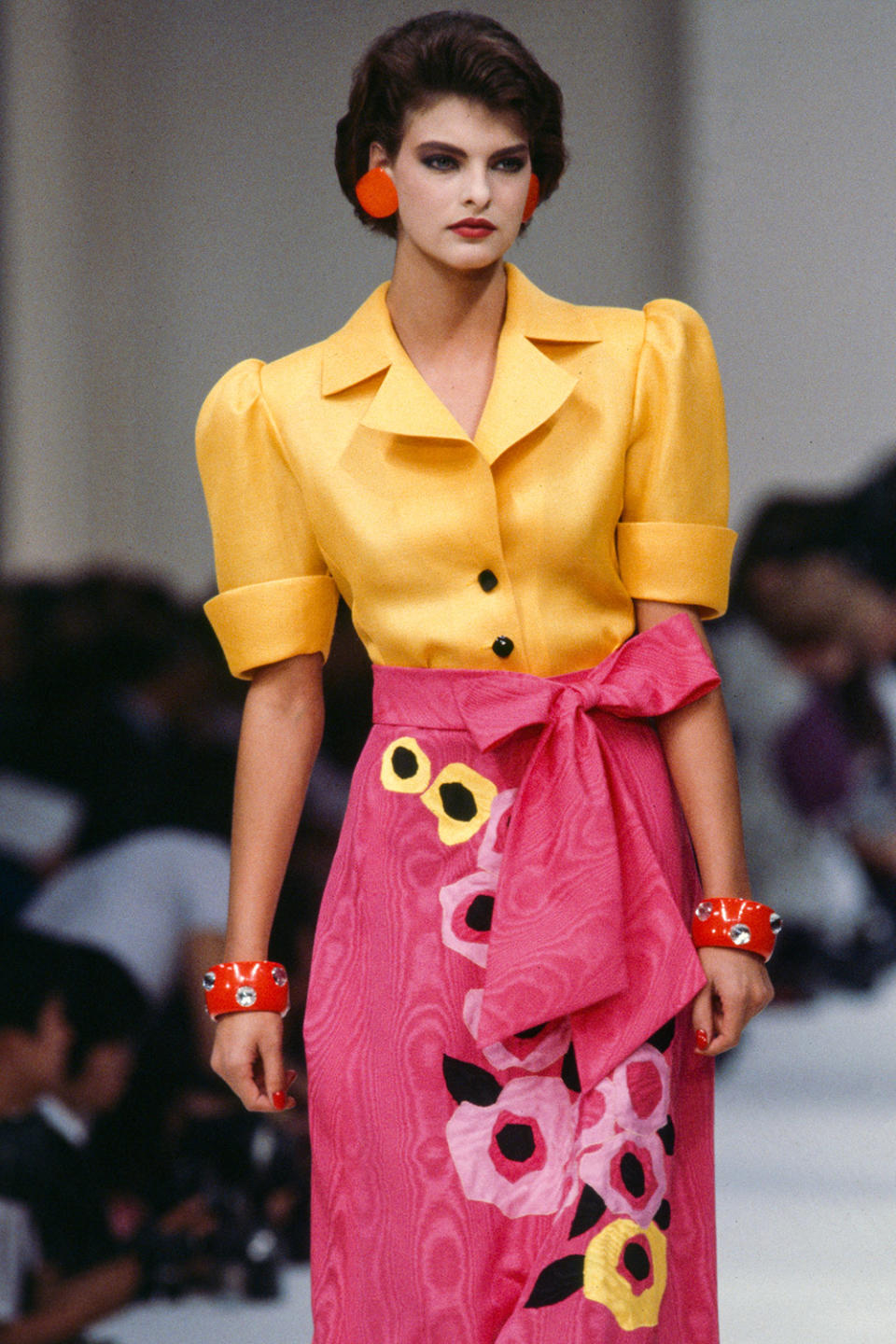 <p>Evangelista's career quickly skyrocketed, and in the mid '80s she found herself on the Paris Fashion Week circuit, seen here in bold hues and prints at the Yves Saint Laurent show in 1985.</p> <p>"People told my mom, 'She's so tall, she should be a model," Evangelista shares. </p>