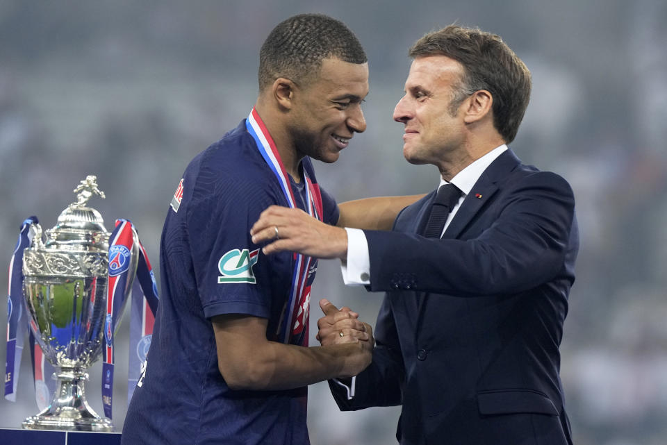 French President Emmanuel Macron greets PSG's Kylian Mbappe during the presentation ceremony after the French Cup final soccer match between Lyon and PSG at the Pierre Mauroy stadium in Villeneuve d'Ascq, northern France, Saturday, May 25, 2024. PSG won the match 2-1. (AP Photo/Michel Euler)