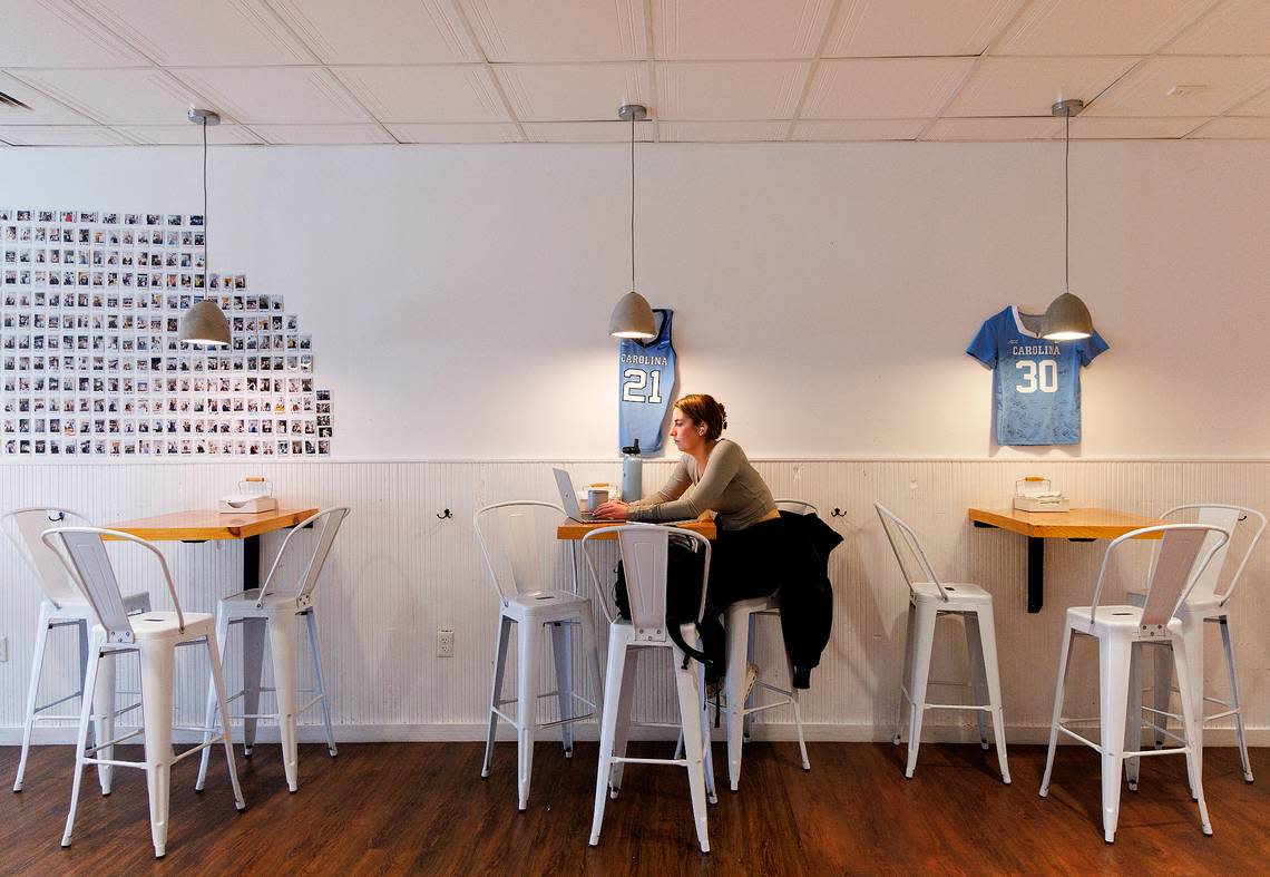 A person works on a laptop inside of The Purple Bowl on Franklin Street on Thursday, Jan. 11, 2024, in Chapel Hill, N.C.