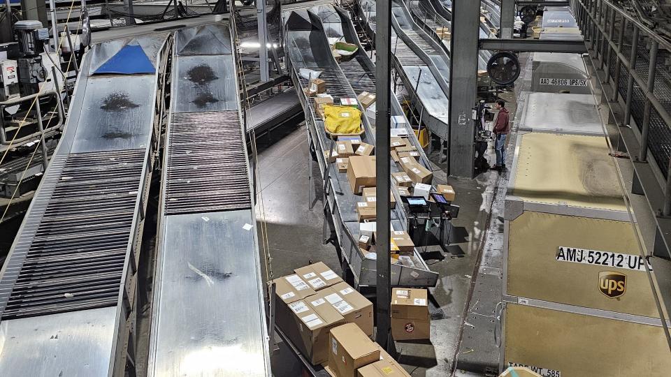 Packages moving through a conveyor system in a warehouse.