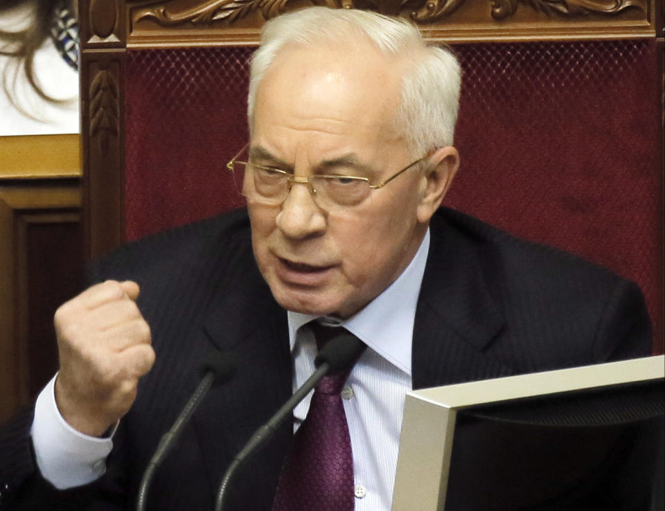 FILE - In this Tuesday, Dec. 3, 2013 file photo, Ukraine's Prime Minister Mykola Azarov speaks to lawmakers during the parliament session in Kiev, Ukraine, Tuesday, Jan. 29, 2014. Azarov offered his resignation in order to encourage what he called "social-political compromise."(AP Photo/Efrem Lukatsky, File )