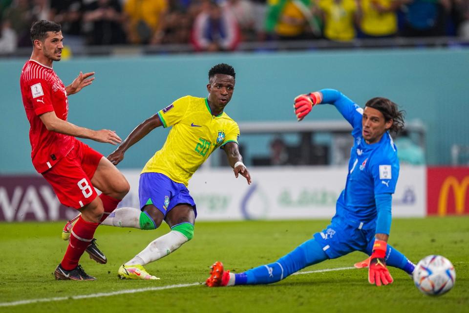 Brazil's Vinicius Junior, center, shoots the ball past Switzerland's goalkeeper Yann Sommer, right, to score a goal that later was disallowed during the World Cup group G football match between Brazil and Switzerland, at the Stadium 974 in Doha, Qatar, Monday, Nov. 28, 2022. (AP Photo/Ariel Schalit)