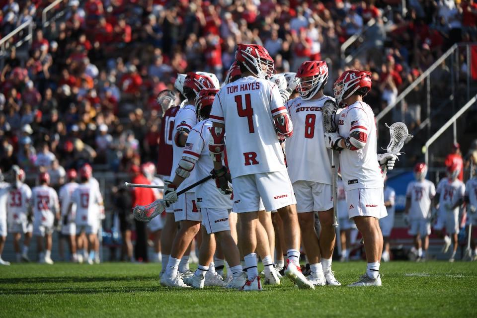 Rutgers lacrosse players huddle during their NCAA win over Harvard