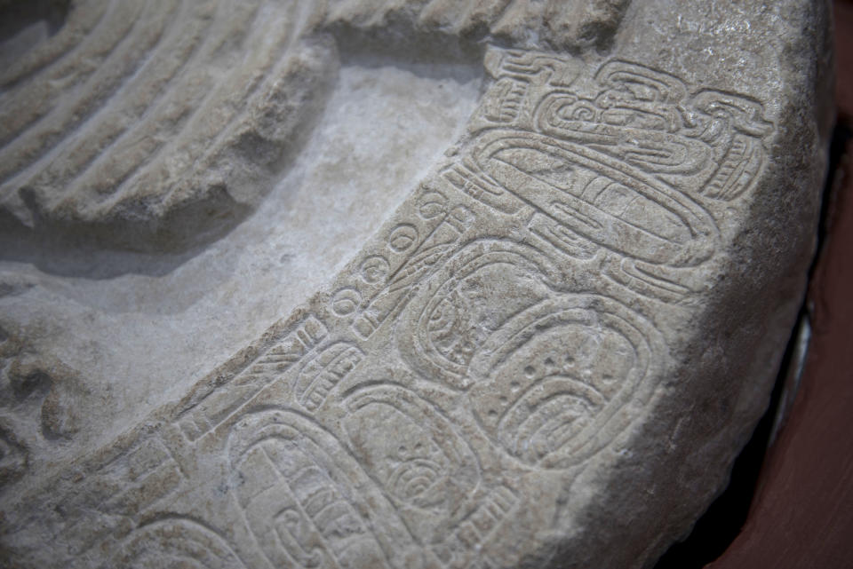 A nearly 1,500-year-old carved altar from the Maya site "La Corona," located in the northern Guatemalan department of Peten, is displayed at the National Museum of Archaeology and Ethnology in Guatemala City, Wednesday, Sept. 12, 2018. Archaeologists in charge of the investigation say that it is the oldest monument found to date in this site of the Classic Maya period. (AP Photo/Oliver de Ros)