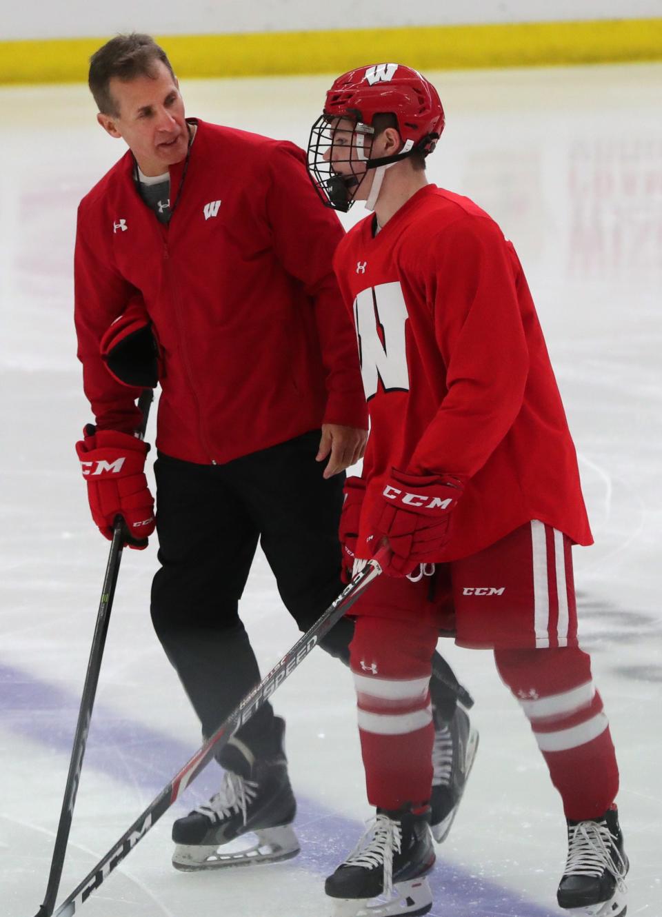 Wisconsin men's hockey coach Tony Granato talks with forward Cole Caufield (8) during practice Tuesday, October 8, 2019 at LaBahn Arena in Madison, Wis. Caufield was the Hobey Baker Award winner that season.