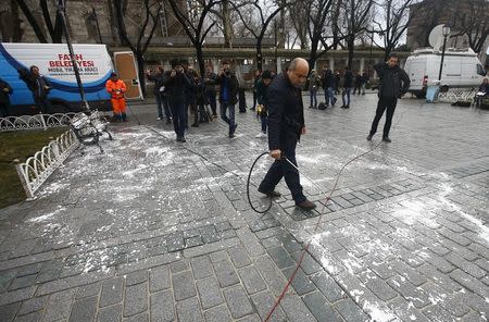 A municipality worker cleans the site of Tuesday's suicide bomb attack at Sultanahmet square in Istanbul, Turkey January 13, 2016. REUTERS/Osman Orsal -
