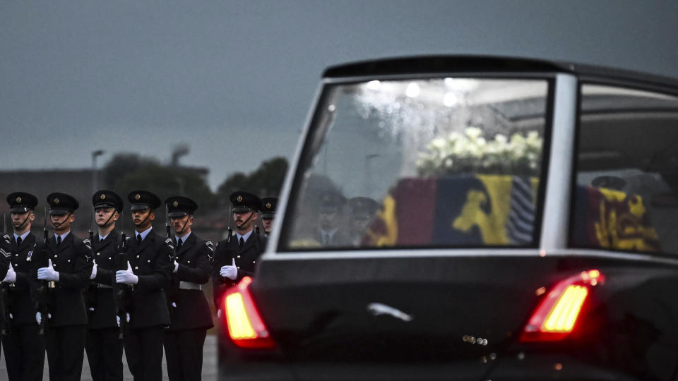 The Queen's Colour Squadron, RAF, stand by as the coffin of Queen Elizabeth II is taken away from the Royal Air Force Northolt airbase, London, Tuesday, Sept. 13, 2022. The queen's coffin is flown back to RAF Northolt, an air force base in London, and driven to Buckingham Palace. (Ben Stansall, Pool Photo via AP)