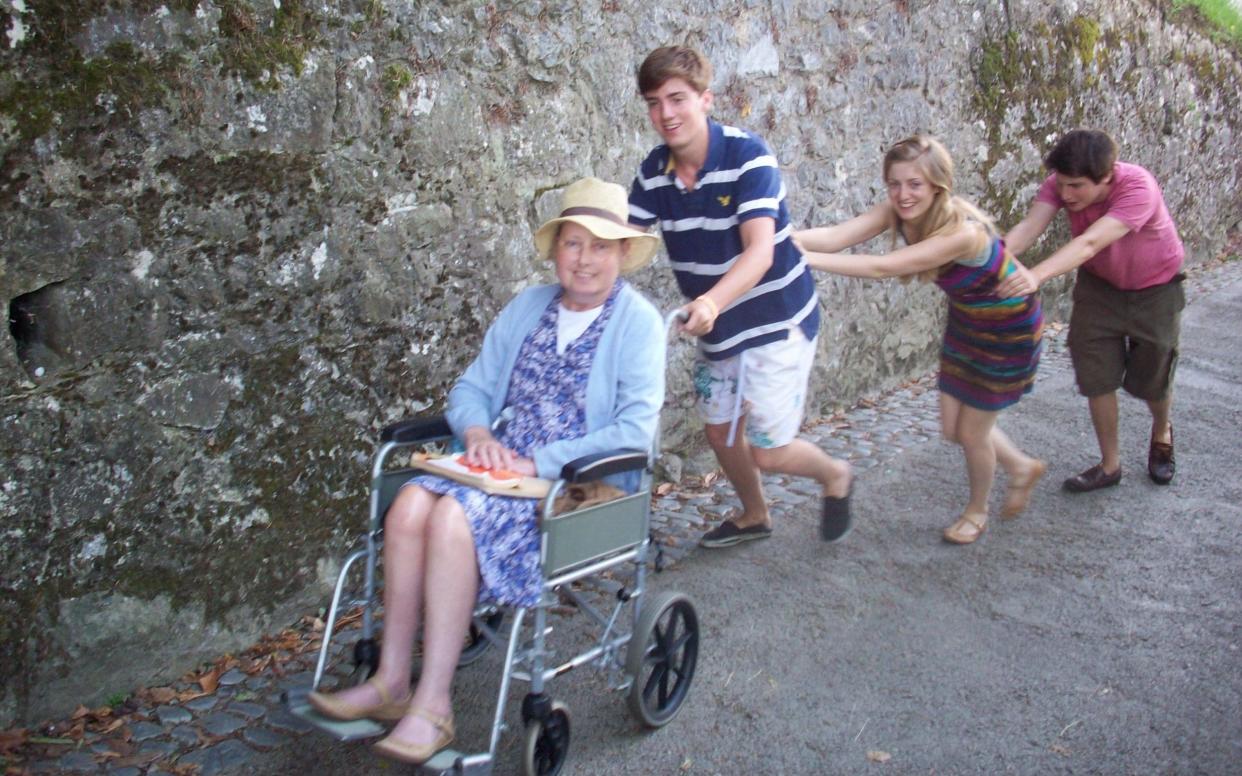 Cancer patient Arabelle Vanneck is pushed by three young members of her family in wheelcahair - Picasa