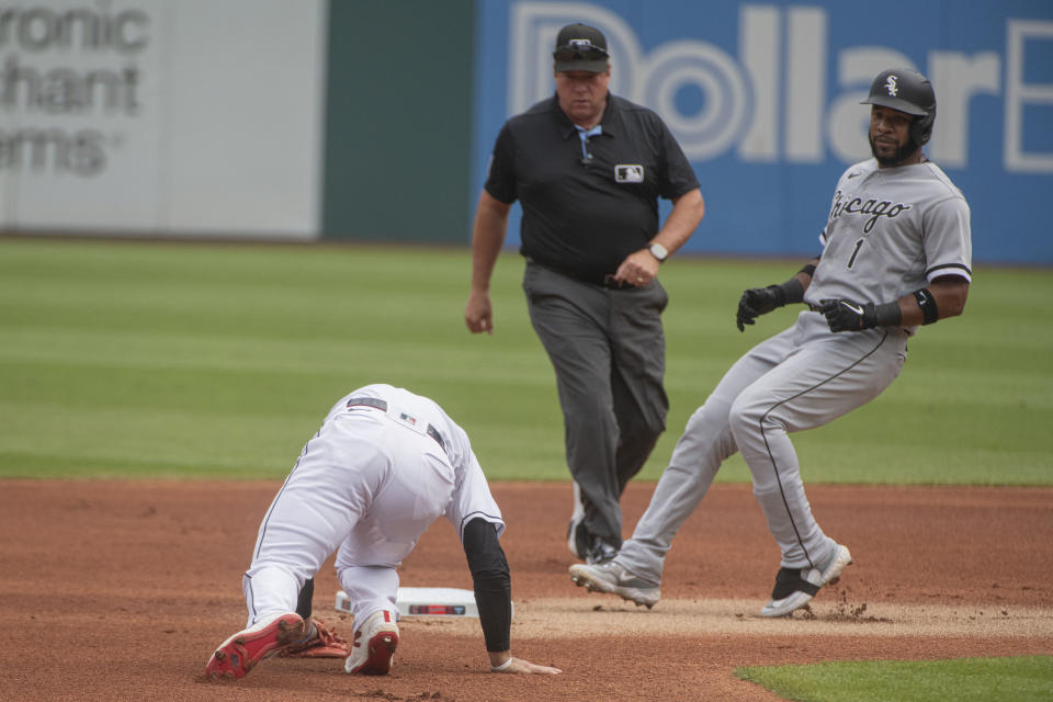 Chicago White Sox' Elvis Andrus (1) stops at second base as Cleveland Guardians' Andres Gimenez stumbles getting to the bag during the first inning of a baseball game in Cleveland, Sunday, Aug. 6, 2023. (AP Photo/Phil Long)