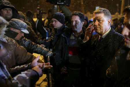 Romanian President Klaus Iohannis speaks to government supporters protesting outside the Presidential Palace in Bucharest, Romania, February 8, 2017. Inquam Photos/Octav Ganea via REUTERS