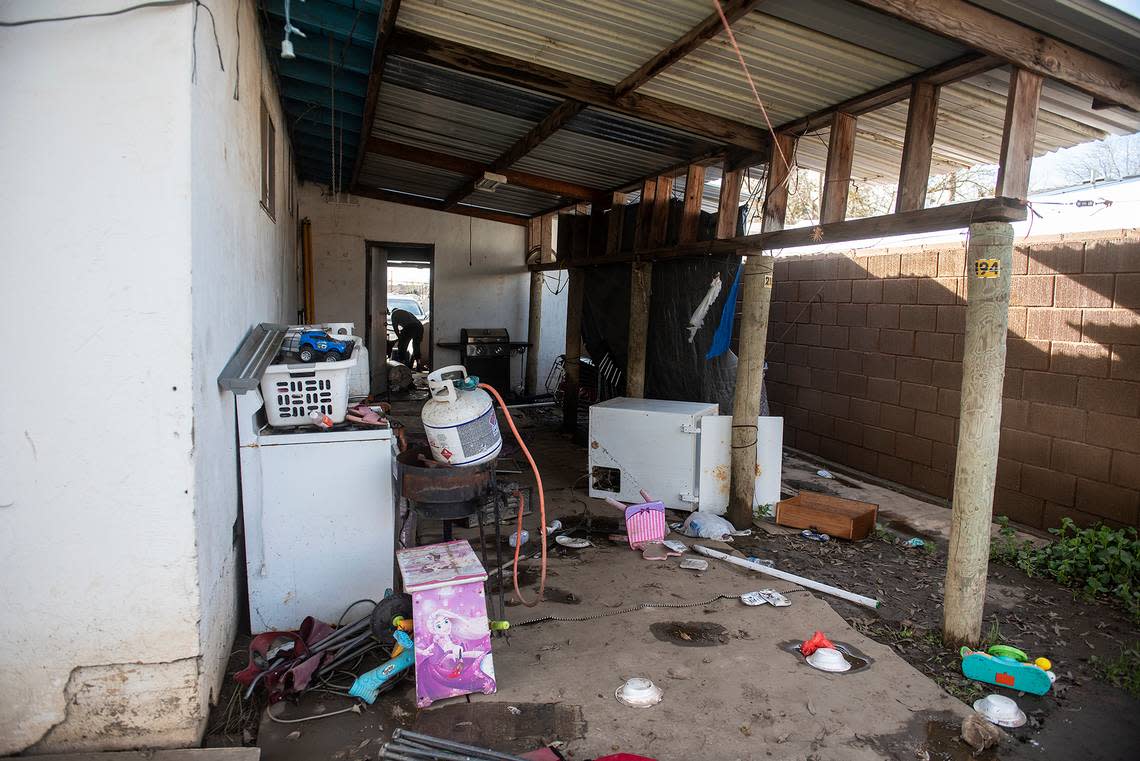 Items damaged by floodwater behind the home of 24-year-old Isabel Ramirez in Planada, Calif., on Thursday, Jan. 12, 2023. According to the Merced County Sheriff’s Office, the evacuation order has been downgraded to a warning.