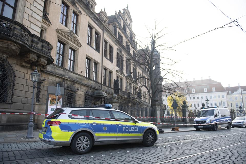 Police cars stand in front of the Residenzschloss, Residence Palace, building in Dresden Monday, Nov. 25, 2019. Authorities in Germany say thieves have carried out a brazen heist at Dresden’s Green Vault, one of the world’s oldest museum containing priceless treasures from around the world. (Sebastian Kahnert/dpa via AP)