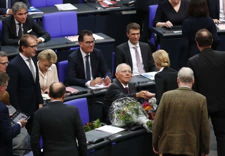 Wolfgang Schaeuble of CDU receives congratulations from Alice Weidel of Alternative for Germany (AfD), after he was elected as Bundestagspraesident during the first plenary session of German lower house of Parliament, Bundestag, after a general election in Berlin, Germany, October 24, 2017. REUTERS/Fabrizio Bensch