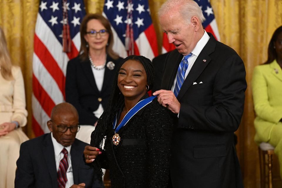 US President Joe Biden presents gymnast Simone Biles with the Presidential Medal of Freedom, the nation's highest civilian honor, during a ceremony honoring 17 recipients, in the East Room of the White House in Washington, DC, July 7, 2022.