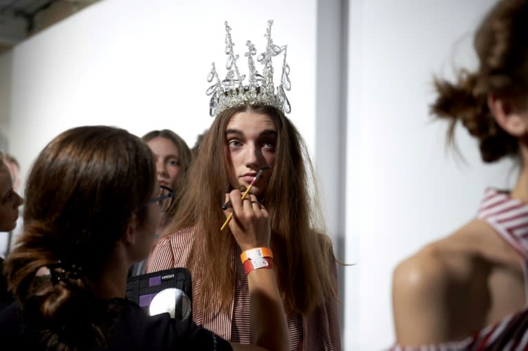 A model gets a last-minute touch-up before Turkish designer Bora Aksu's show at London Fashion Week