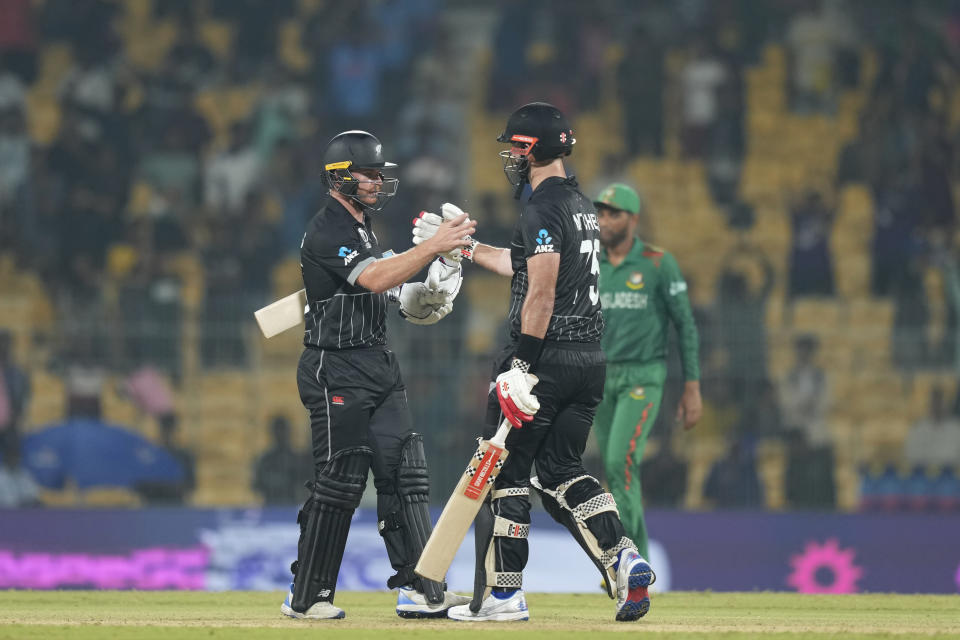 New Zealand's Glenn Phillips ,left, along with New Zealand's Daryl Mitchell celebrate their win against Bangladesh in the ICC Men's Cricket World Cup match in Chennai , India, Friday, Oct. 13, 2023. (AP Photo/Eranga Jayawardena)