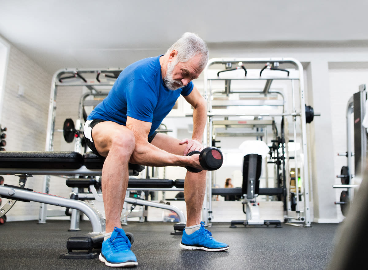 senior man doing dumbbell curls