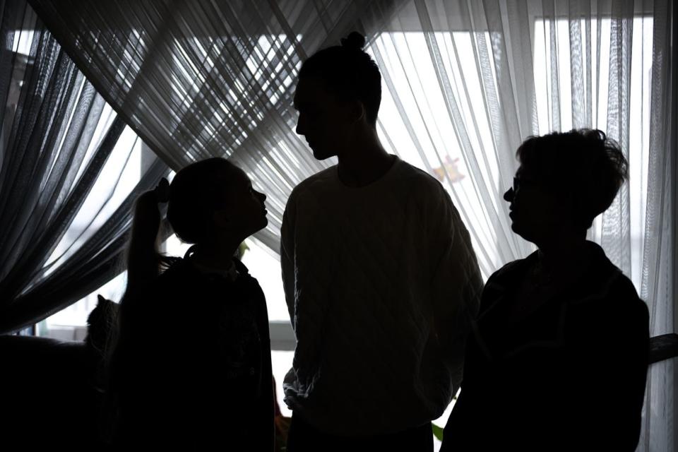 Varvara (L), Matvii (C) and Nataliia Motorna in their house in Kyiv, Ukraine. (Viacheslav Ratynskyi / The Kyiv Independent)