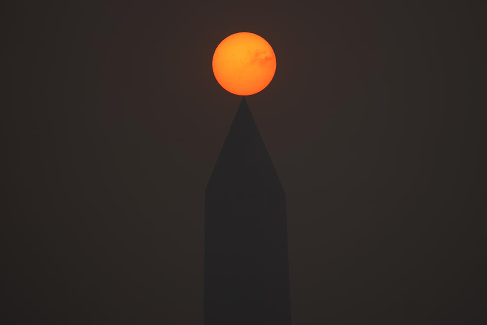 <p>The sun rises above the Washington Monument and a thick layer of smoke, Thursday, June 8, 2023, in Washington. Intense Canadian wildfires are blanketing the northeastern U.S. in a dystopian haze, turning the air acrid, the sky yellowish gray and prompting warnings for vulnerable populations to stay inside. (AP Photo/Julio Cortez)</p> 