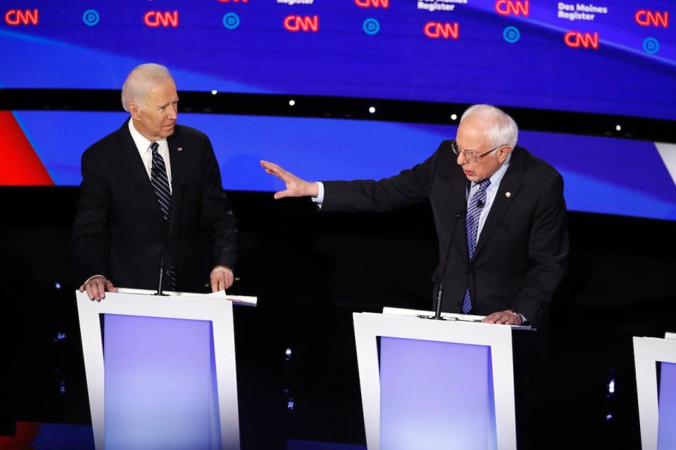 Democratic presidential candidate former Vice President Joe Biden, left, watches as Sen. Bernie Sanders, I-Vt., answers a question Tuesday, Jan. 14, 2020, during a Democratic presidential primary debate hosted by CNN and the Des Moines Register in Des Moines, Iowa.