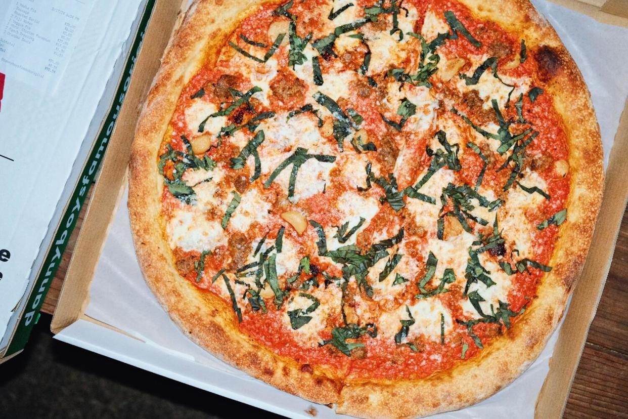 An overhead photo of a whole vodka-sauce pizza with sausage and basil from Danny Boy's Famous Original