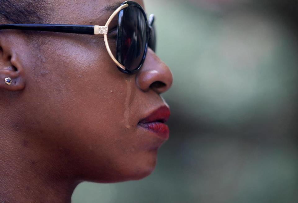 A tear runs down Shanelle Jenkins cheek as she listens to family members describe what happened to Kelly Masten during a rally outside the Tarrant County commissioners meeting on May 10, 2022, to demand changes at Tarrant County’s jails.