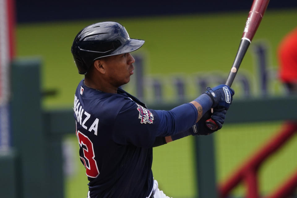 Atlanta Braves' Ehire Adrianza follows through on a two-run base hit in the fifth inning of a spring training baseball game against the Boston Red Sox, Saturday, March 20, 2021, in North Port, Fla.. (AP Photo/John Bazemore)