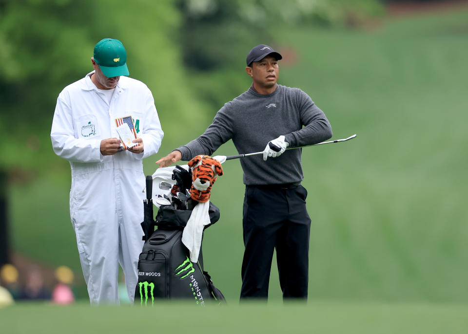 AUGUSTA, GEORGIA - APRIL 09: Tiger Woods of The United States prepares to play a shot with his caddie Lance Bennett during a practice round prior to the 2024 Masters Tournament at Augusta National Golf Club on April 09, 2024 in Augusta, Georgia. (Photo by David Cannon/Getty Images)