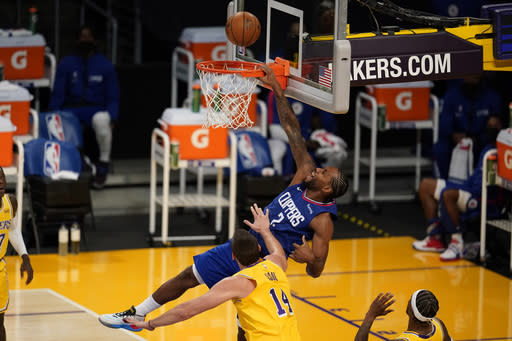 Los Angeles Clippers forward Kawhi Leonard (2) misses on a dunk attempt over Los Angeles Lakers center Marc Gasol (14) during the first half of an NBA basketball game Tuesday, Dec. 22, 2020, in Los Angeles. (AP Photo/Marcio Jose Sanchez)