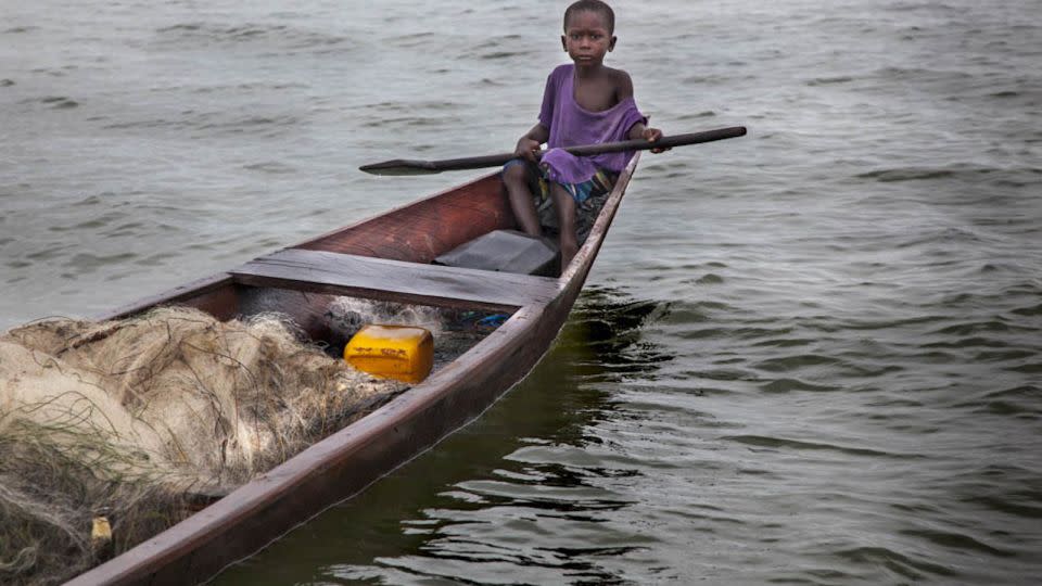 A boy working on a fishing boat in Ghana. - Lisa Kristine