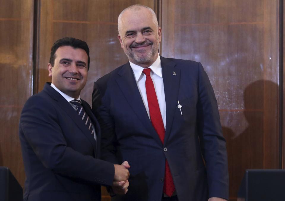 North Macedonia's Prime Minister Zoran Zaev, left, and his Albanian counterpart Edi Rama shake hands during their meeting in Tirana, Wednesday, March 13, 2019. The two leaders say they believe that the European Union will decide in June to open membership talks with them. (AP Photo)