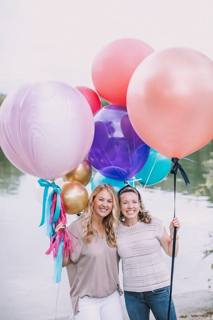 Colleen Martin, left, and Ashley Reed pose with some of the balloons used in their Bearden business, The Balloon Garden.