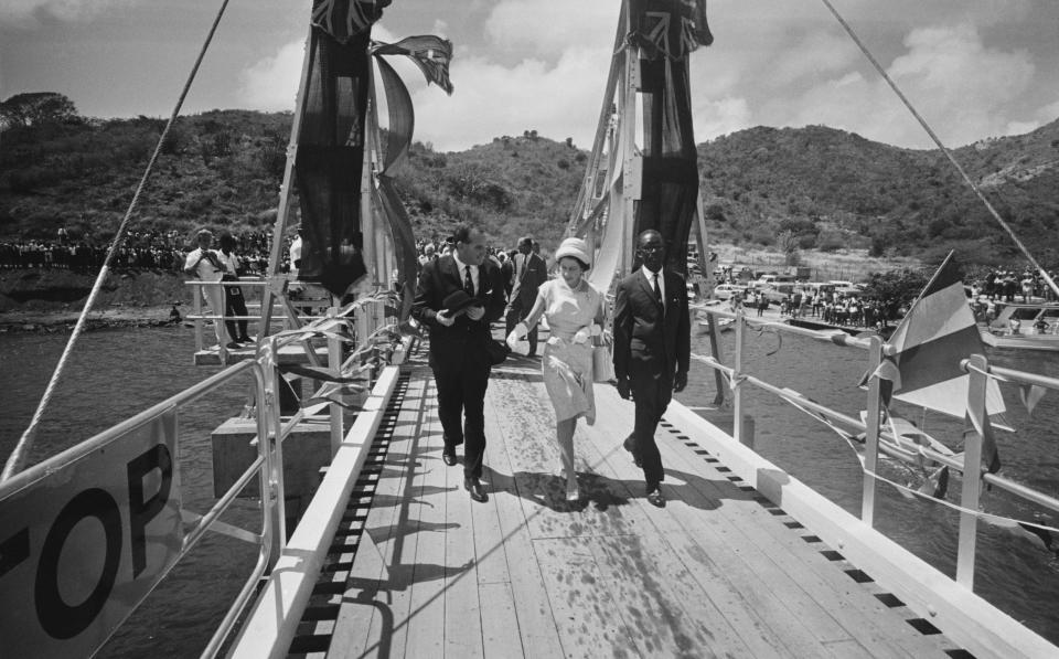  Queen Elizabeth II walking along a jetty at Tortola in the British Virgin Islands - Harry Benson/Hulton Royals Collection