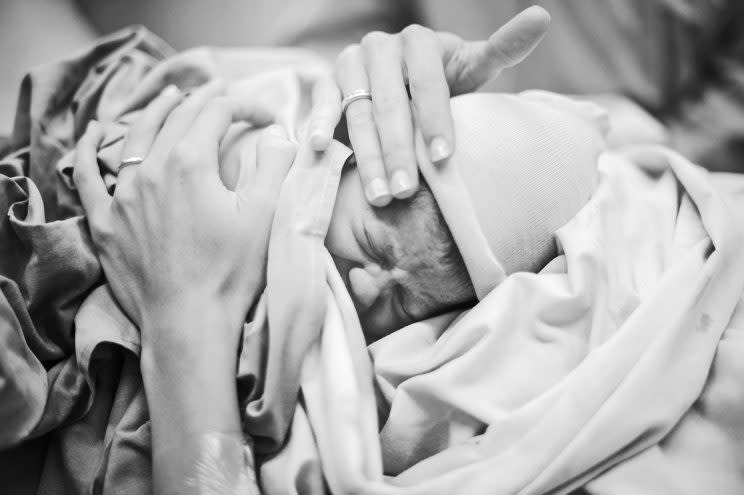 A mother holds a newborn baby