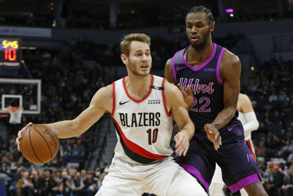 Portland Trail Blazers' Jake Layman, left, drives in front of Minnesota Timberwolves' Andrew Wiggins during the first half of an NBA basketball game Friday, Nov. 16, 2018, in Minneapolis. (AP Photo/Jim Mone)