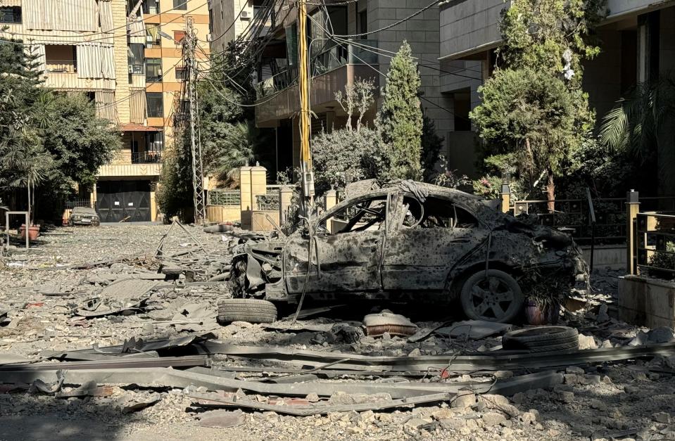 The burnt out shell of car remains on a street in southern Beirut after overnight Israeli airstrikes (REUTERS)