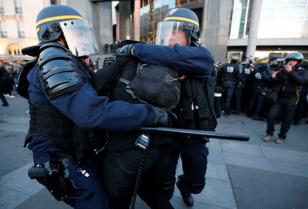 French riot police clash with demonstrators after partial results in the first round of 2017 French presidential election, in Paris, France April 23, 2017. REUTERS/Jean-Paul Pellisier