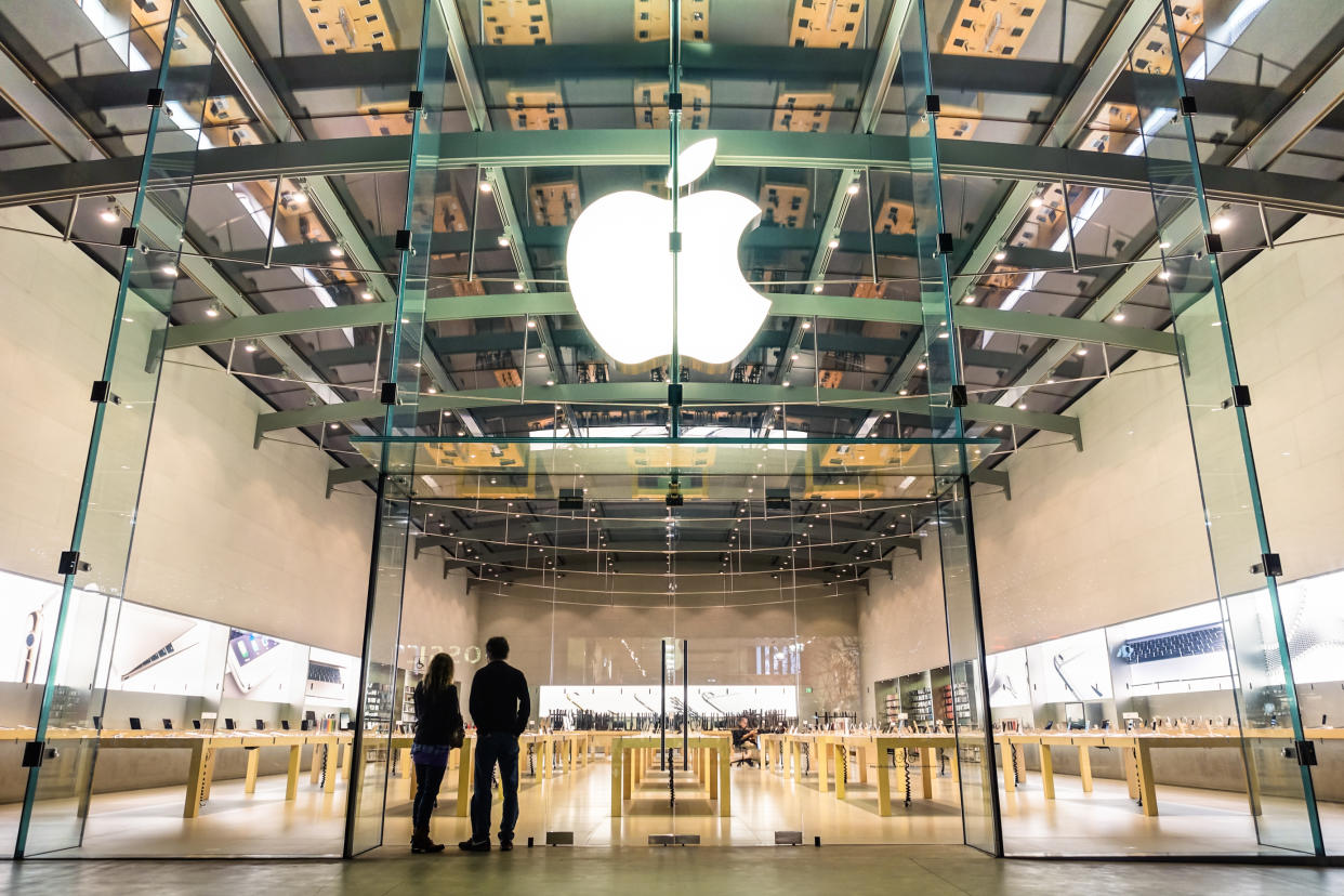 Santa Monica, United States - 21 March,  2015: two unidentified persons watching inside the Apple store on 3rd Street Promenade in Santa Monica near Los Angeles in California. The retail chain owned and operated by Apple Inc is dealing with computers and electronics worldwide, with 453 retail stores in 16 countries.