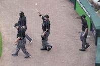 Umpire Joe West, foreground left, leads his crew of Bruce Dreckman, top left, Dan Bellino, tossing the ball to the mound and Nic Lentz on the field before an interleague baseball game between the Chicago White Sox and the St. Louis Cardinals, Monday, May 24, 2021, in Chicago. West now ties the major league record for games umpired. (AP Photo/Charles Rex Arbogast)