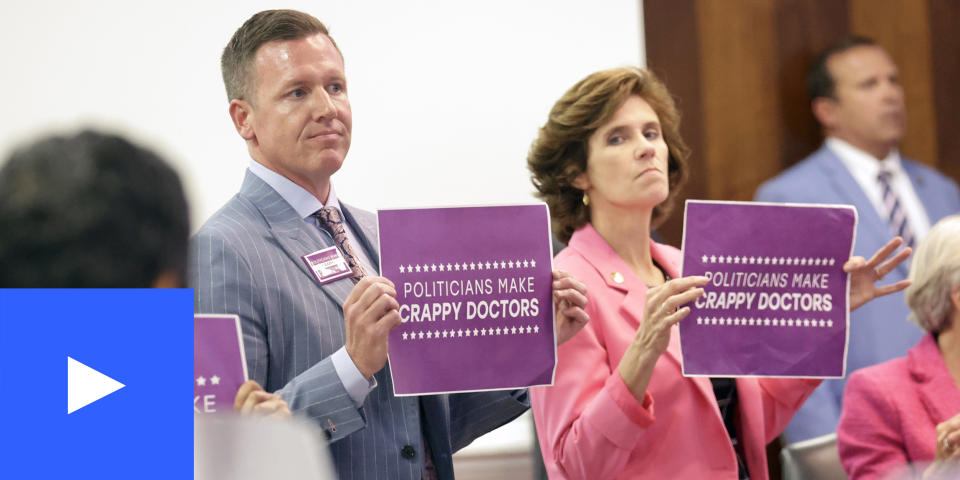 Democratic Sens. Michael Garrett, holding sign at left, and Natasha R. Marcus, and other Democrats hold signs in protest, Tuesday, May 16, 2023, in Raleigh, N.C., after the state Senate voted to override Democratic Gov. Roy Cooper's veto of a bill that would change the state's ban on nearly all abortions from those after 20 weeks of pregnancy to those after 12 weeks of pregnancy. Both the Senate and House had to complete successful override votes for the measure to be enacted into law. (Chris Seward / AP)