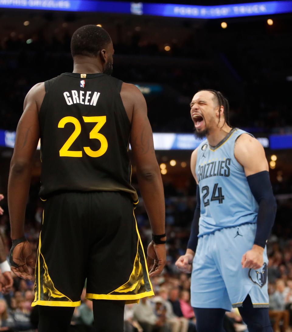 The Memphis Grizzlies forward Dillon Brooks (24) reacts after teammate Jaren Jackson Jr. (13) scores the ball plus the foul against the Golden State Warriors forward Draymond Green (23) during a game at the Fedex Forum on Mar. 18, 2023 in Memphis.