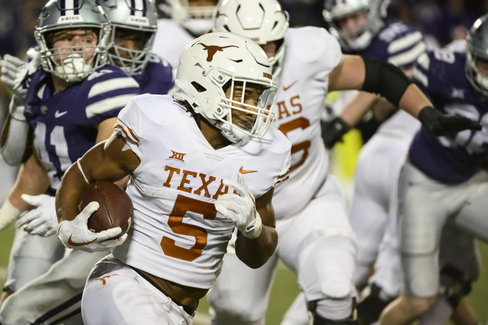 Texas running back Bijan Robinson (5) carries against Kansas State during the second half of an NCAA college football game Saturday, Nov. 5, 2022, in Manhattan, Kan. (AP Photo/Reed Hoffmann)