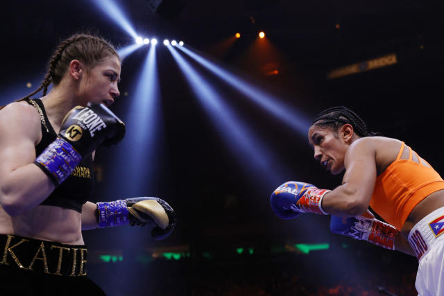 NEW YORK, NEW YORK - APRIL 30: Katie Taylor of Ireland (black trunks) trades punches with Amanda Serrano of Puerto Rico (white trunks) for the World Lightweight Title fight at Madison Square Garden on April 30, 2022 in New York, New York. This bout marks the first women&#x002019;s boxing fight to headline Madison Square Garden in the venue&#x002019;s history. Taylor defeated Serrano on a judges decision. (Photo by Sarah Stier/Getty Images)